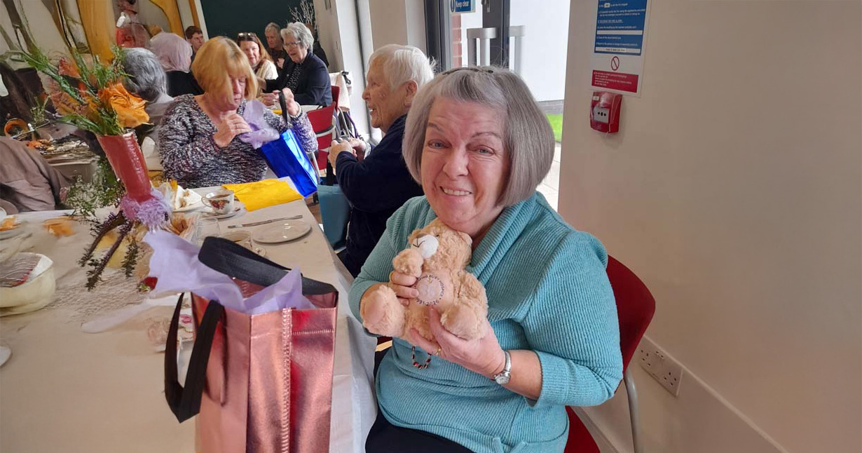 Volunteer with 35th anniversary teddy